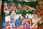 Luang Prabang, Laos - Wat Xieng Mouan with the faade decorated with brightly painted Jataka tales. 